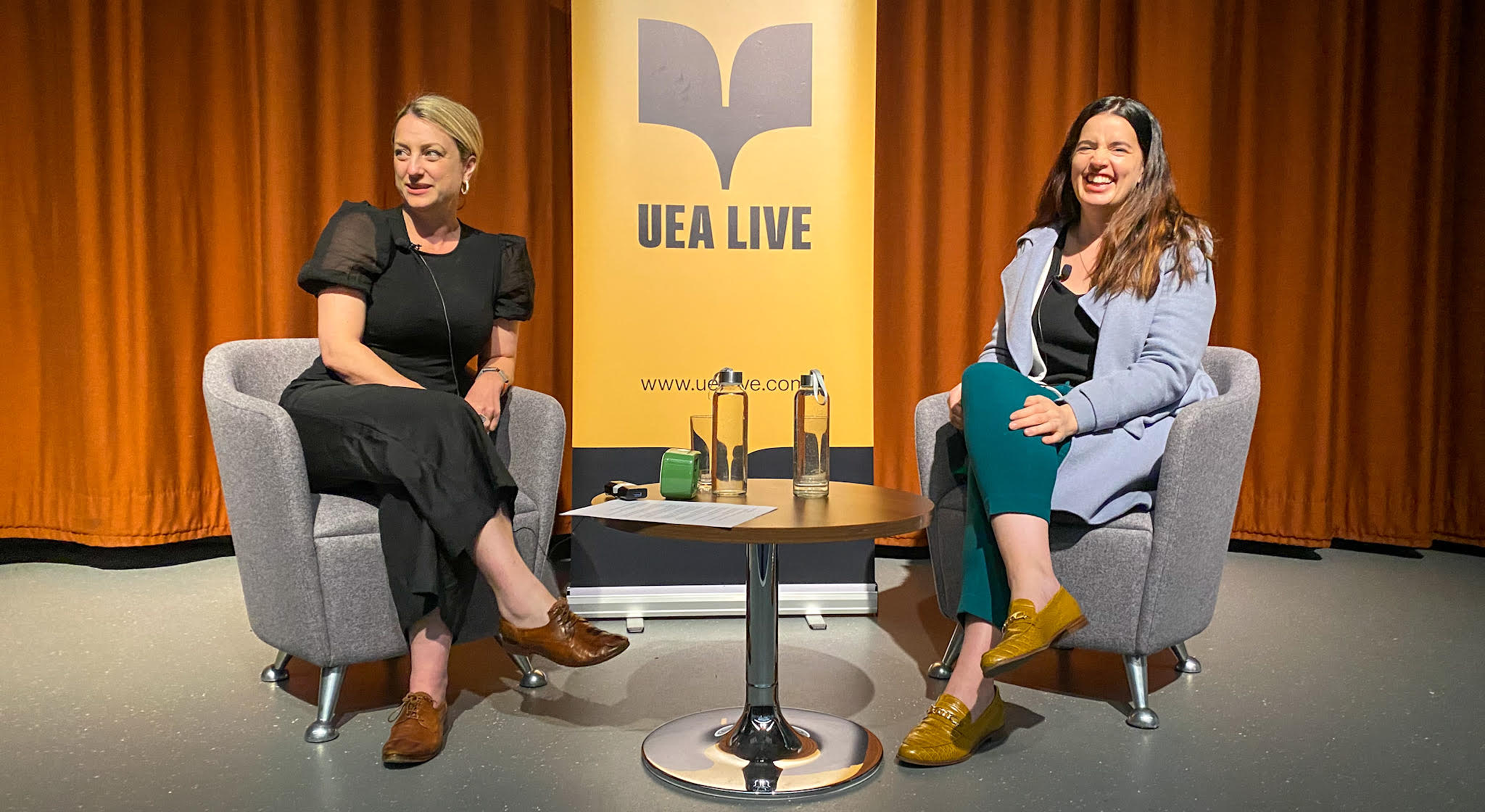 Christie Watson and Kate Bowler sat on stage, in front of a UEA Live banner